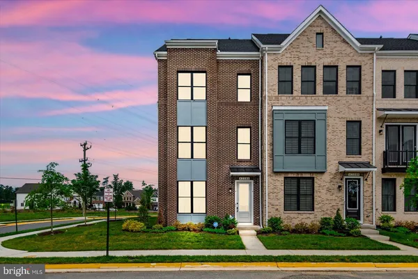 a front view of a residential apartment building with a yard