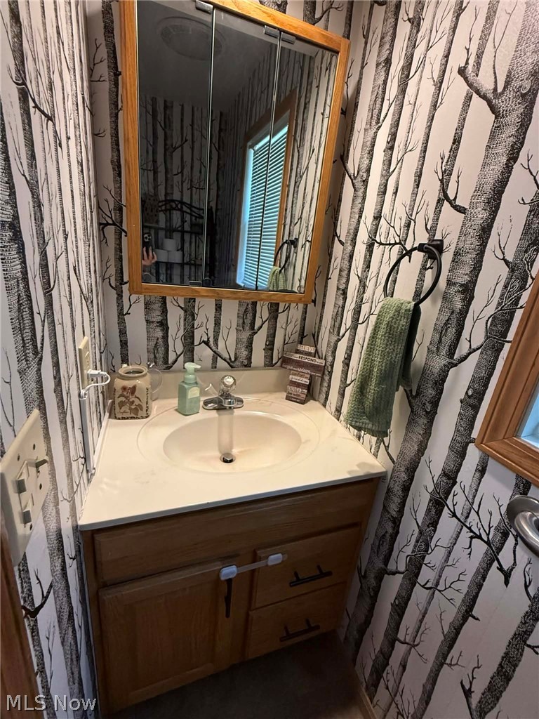 7170 Old Town Road Mount Perry, OH 43760 - Photo 18 of 41 Bathroom with vanity and wallpapered walls
