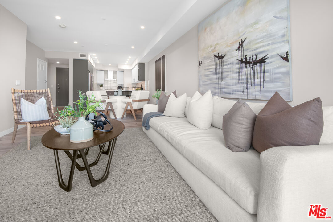 1226 South Bedford Street, Unit 504 Los Angeles, CA 90035 - Photo 3 of 16 a living room with furniture and a table