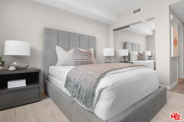 a bedroom with a bed and a lamp