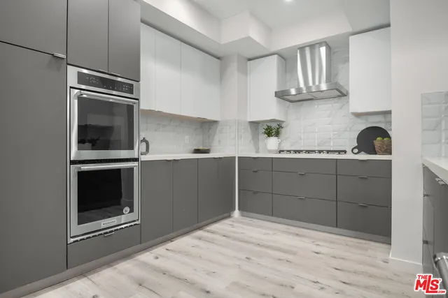 a kitchen with cabinets and stainless steel appliances