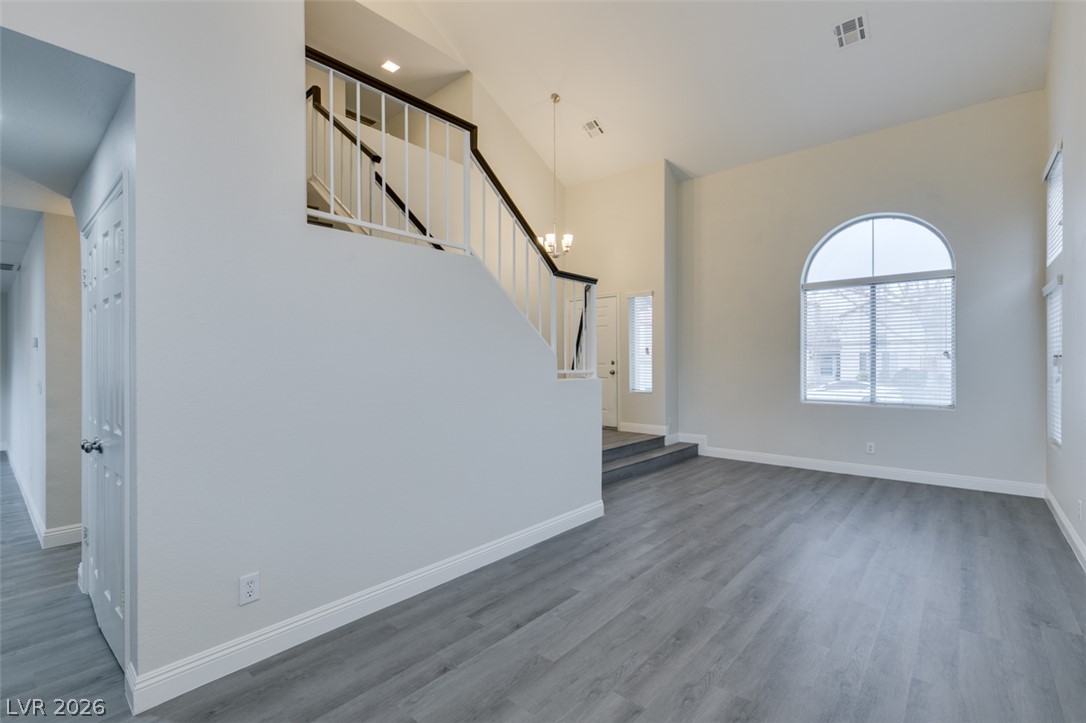 1738 Toltec Circle Henderson, NV 89014 - Photo 19 of 46 A spacious entrance with a grand staircase and a striking arched window.