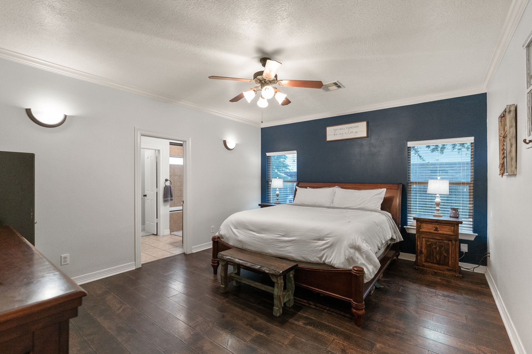 5942 Wildflower Road Sealy, TX 77474 - Photo 12 of 41 a bedroom with a bed and a chandelier