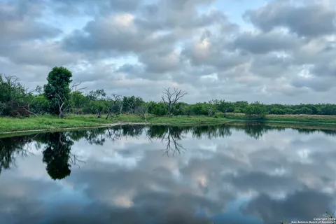 a view of a lake with a yard
