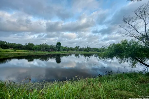 a view of a lake with houses in the back