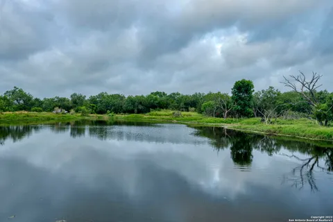 a view of a swimming pool and lawn chairs