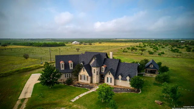 a living room with furniture a large window and a fireplace