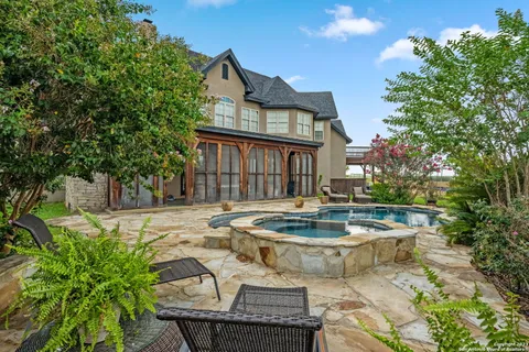 a view of swimming pool with outdoor seating and plants