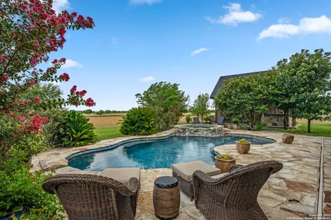 a view of a patio with table and chairs with wooden floor and fence