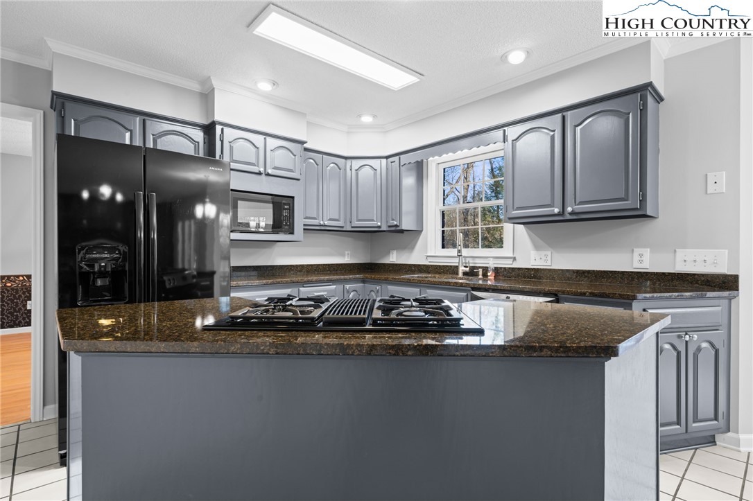 458 Jim Caudill Road Wilkesboro, NC 28697 - Photo 12 of 50 a kitchen with kitchen island granite countertop a sink cabinets and stainless steel appliances