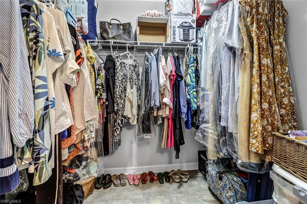 9175 Celeste Drive, Unit 2202 Naples, FL 34113 - Photo 20 of 27 a view of walk in closet with clothes