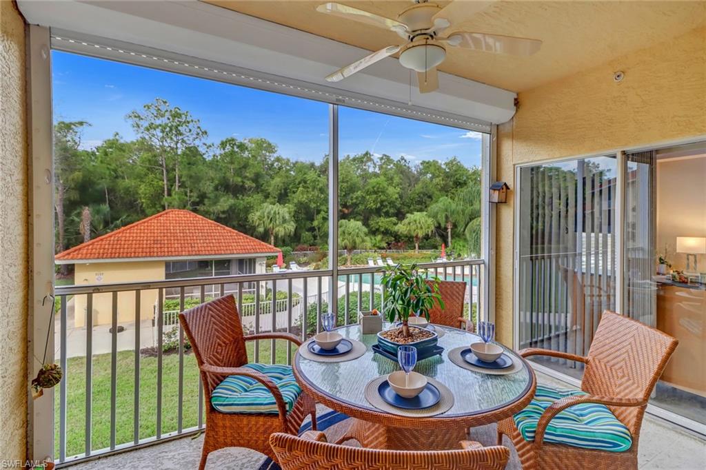 9175 Celeste Drive, Unit 2202 Naples, FL 34113 - Photo 3 of 27 a patio with a table and chairs