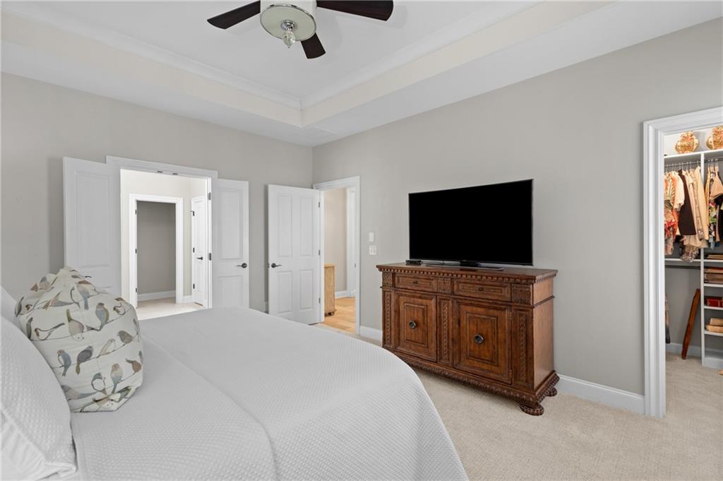 4469 Tacoma Trace Suwanee, GA 30024 - Photo 13 of 62 a bedroom with a bed and a flat screen tv