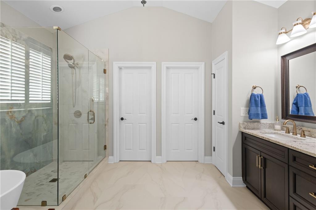 4469 Tacoma Trace Suwanee, GA 30024 - Photo 14 of 62 a bathroom with a double vanity sink toilet and shower