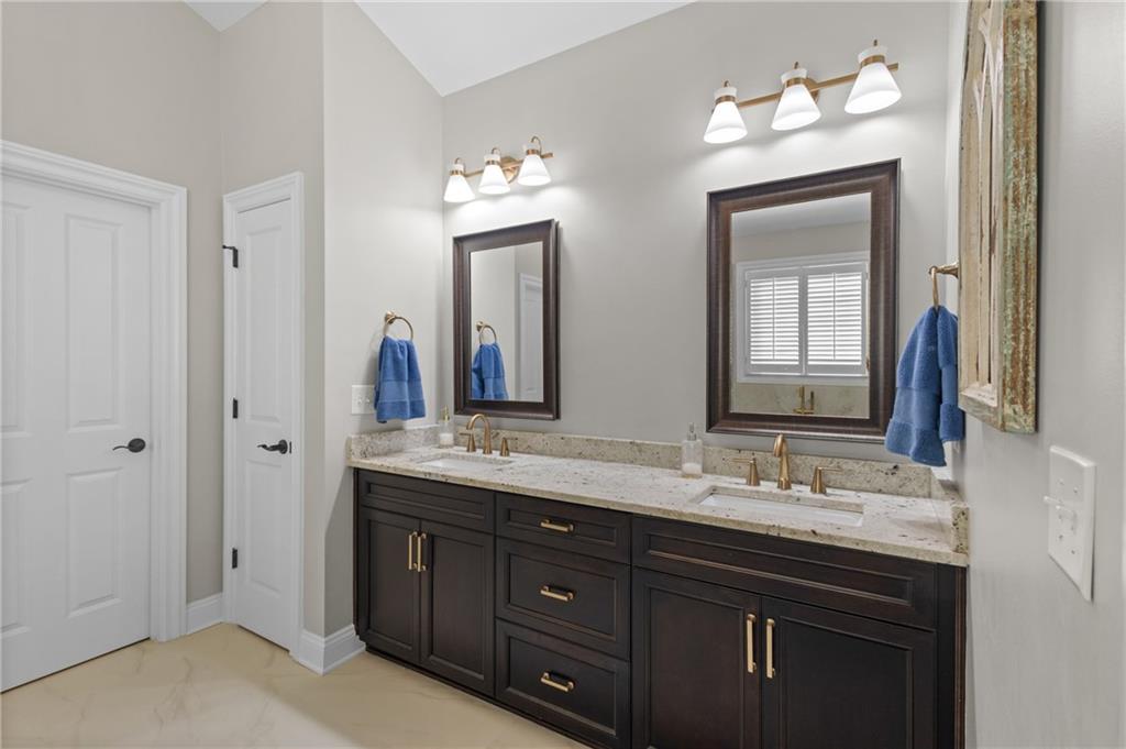 4469 Tacoma Trace Suwanee, GA 30024 - Photo 15 of 62 a bathroom with double vanity sinks and a mirror