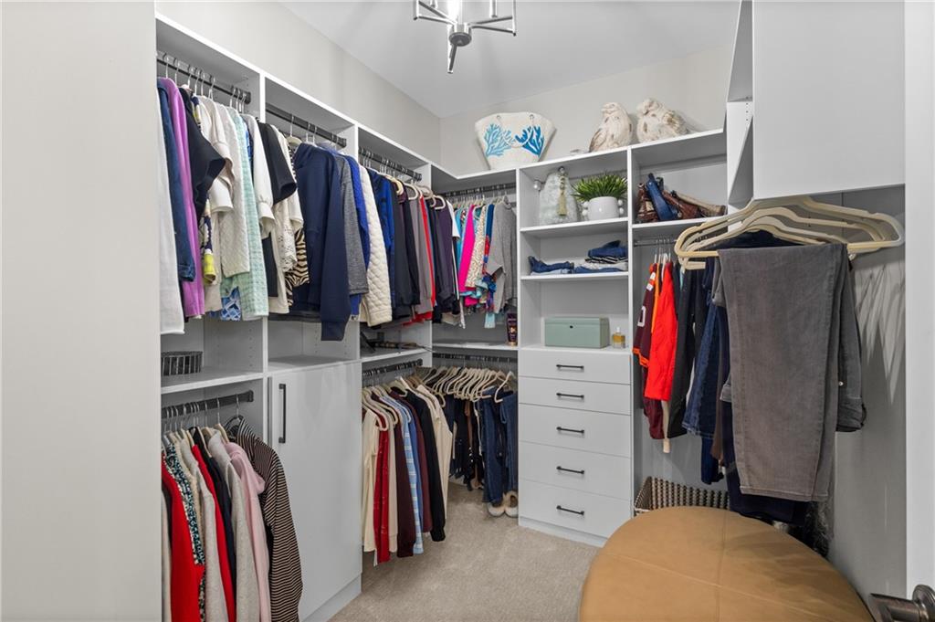 4469 Tacoma Trace Suwanee, GA 30024 - Photo 17 of 62 a view of walk in closet with clothes and shoes