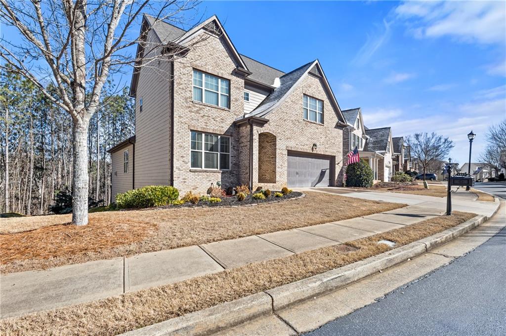4469 Tacoma Trace Suwanee, GA 30024 - Photo 2 of 62 a front view of a house with a yard