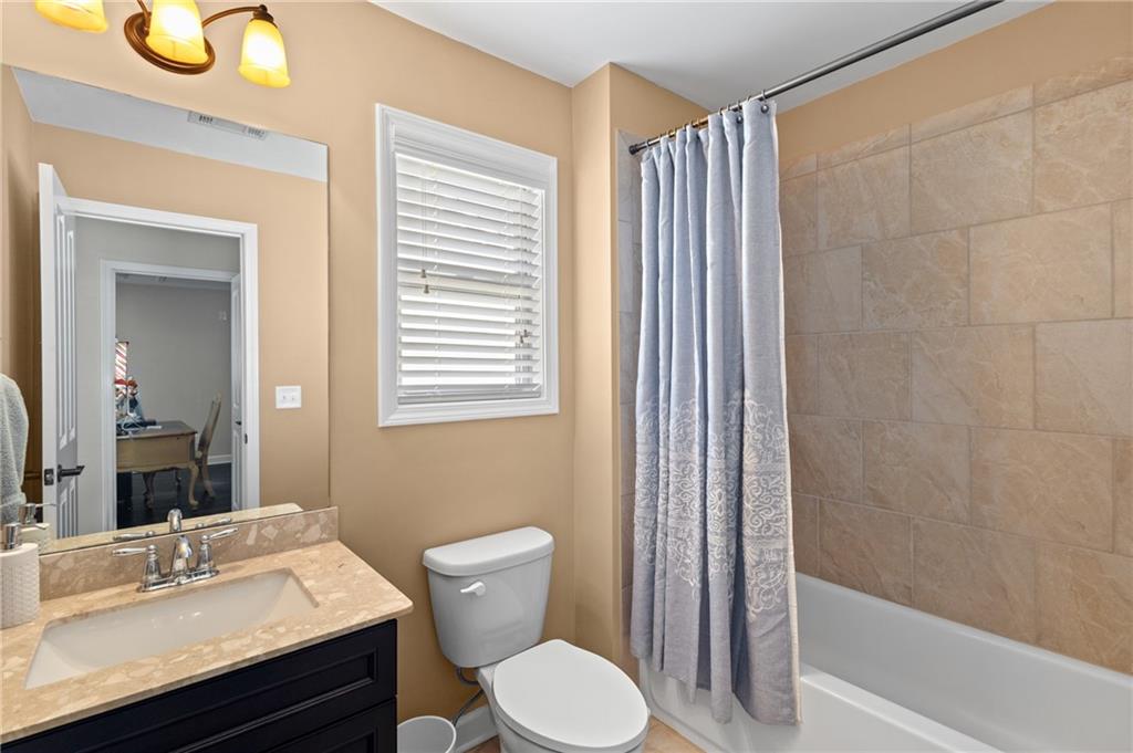 4469 Tacoma Trace Suwanee, GA 30024 - Photo 23 of 62 a bathroom with a sink toilet and shower