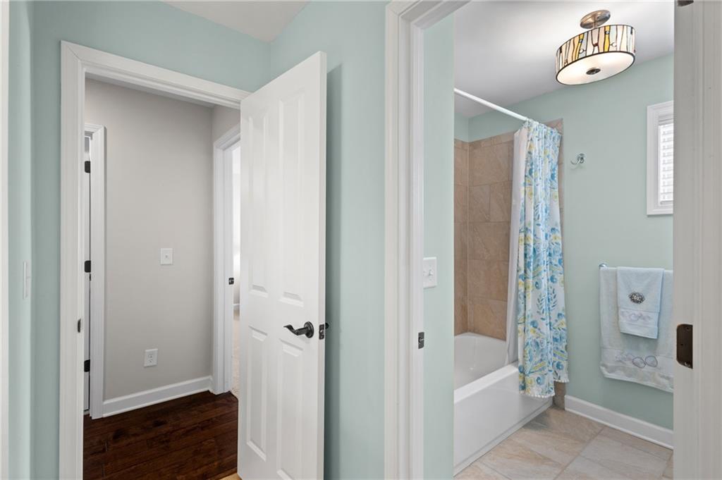 4469 Tacoma Trace Suwanee, GA 30024 - Photo 27 of 62 a bathroom with a bathtub and a shower
