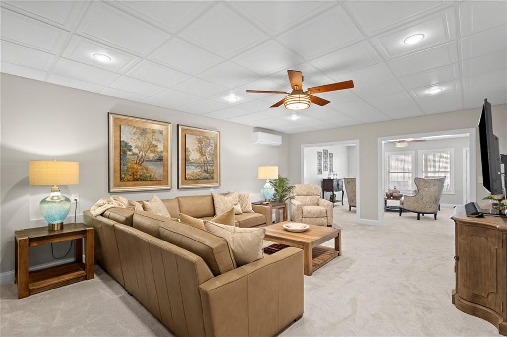 4469 Tacoma Trace Suwanee, GA 30024 - Photo 29 of 62 a living room with furniture ceiling fan and a window