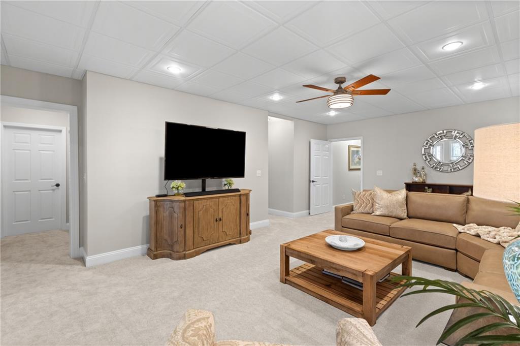 4469 Tacoma Trace Suwanee, GA 30024 - Photo 31 of 62 a living room with furniture and a flat screen tv