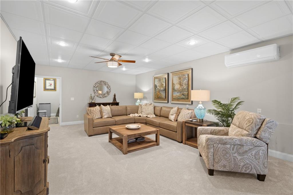 4469 Tacoma Trace Suwanee, GA 30024 - Photo 32 of 62 a living room with furniture and a flat screen tv