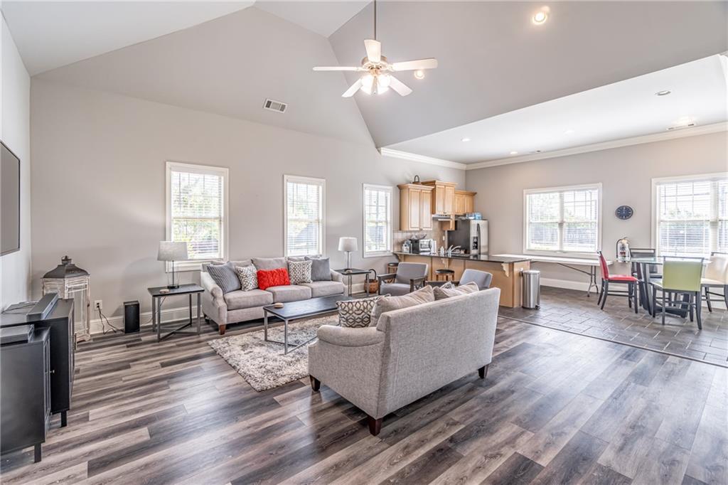 4469 Tacoma Trace Suwanee, GA 30024 - Photo 60 of 62 a living room with furniture kitchen view and a wooden floor