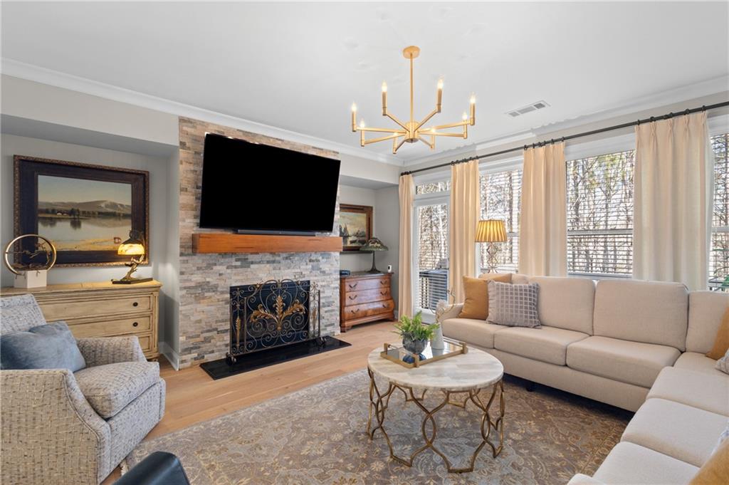 4469 Tacoma Trace Suwanee, GA 30024 - Photo 9 of 62 a living room with furniture a flat screen tv and a fireplace