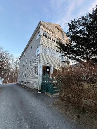 a view of a house with a tree