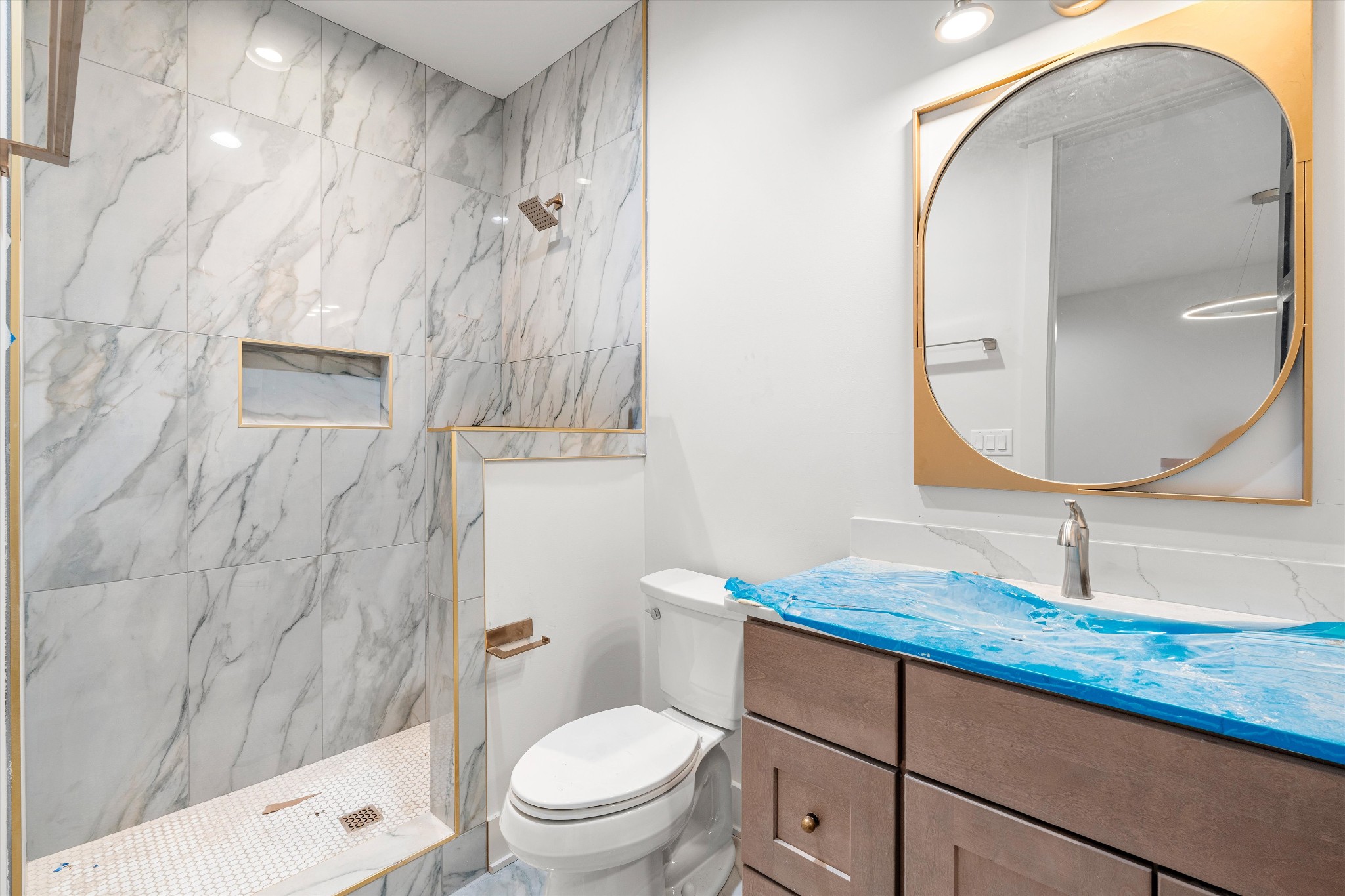 1007 Sevier Street Nashville, TN 37206 - Photo 11 of 55 a bathroom with a granite countertop sink toilet a mirror and vanity