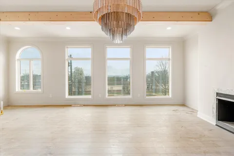 a view of a livingroom with a ceiling fan and window