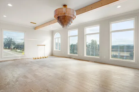 a view of a kitchen with kitchen island stainless steel appliances wooden floor and window