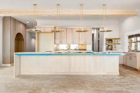 a kitchen with counter top space and windows