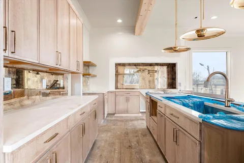 a kitchen with stainless steel appliances kitchen island granite countertop a sink and cabinets