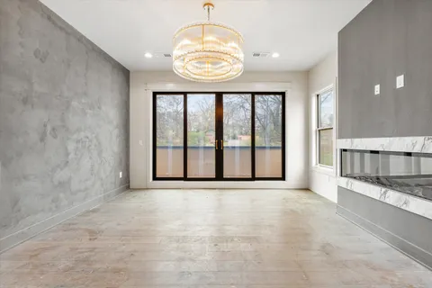 a view of an empty room with a fireplace and a large window
