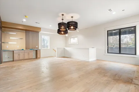 an empty room with windows and furniture