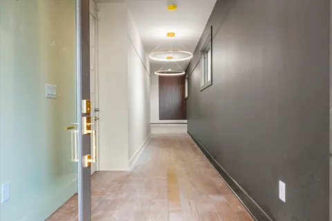 a view of a hallway with wooden floor