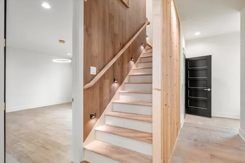 a view of staircase with white walls and windows