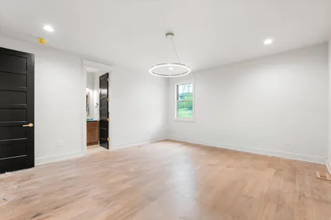 a bathroom with a granite countertop sink toilet a mirror and vanity