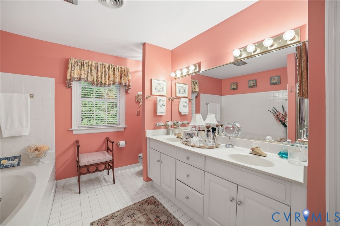 3950 Reeds Landing Circle Midlothian, VA 23113 - Photo 23 of 50 a en suite bathroom with a sink mirror and a bathtub