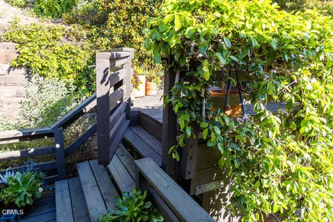 a view of a patio with a table and chairs next to a yard