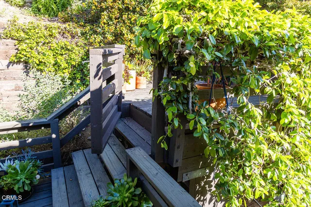 a view of a patio with a table and chairs next to a yard