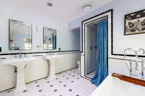 a bathroom with a bathtub and a window