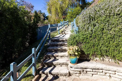 a aerial view of a house with a yard and table and chairs