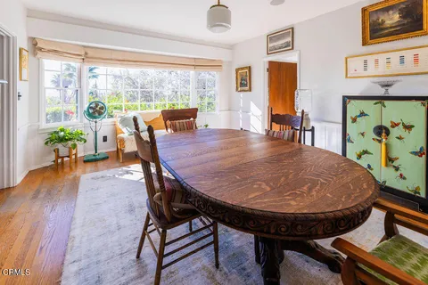 a view of a dining room with furniture window and wooden floor