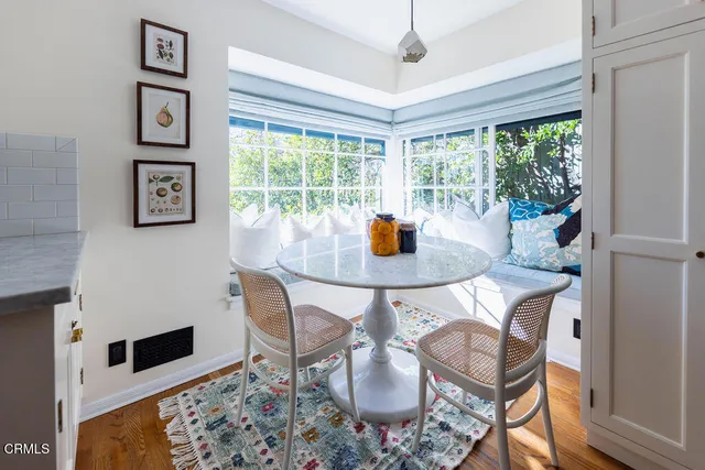 a dining room with furniture a chandelier and wooden floor