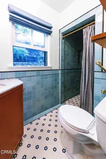 a white toilet sitting next to a bathroom sink