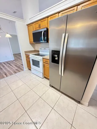 a kitchen with stainless steel appliances a stove a sink and a refrigerator