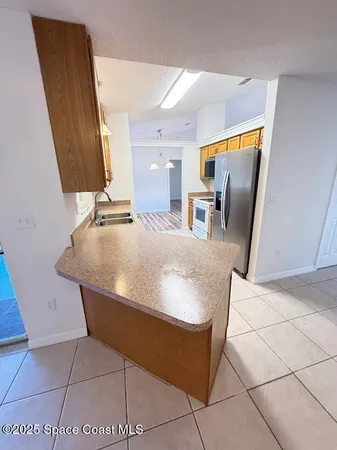 a view of kitchen with furniture and counter top