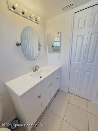 a bathroom with a sink a mirror and vanity
